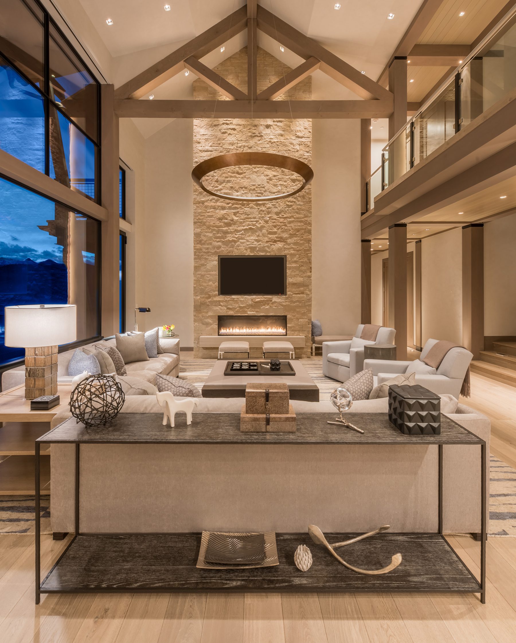 Great room with vaulted timber ceiling and stone fireplace