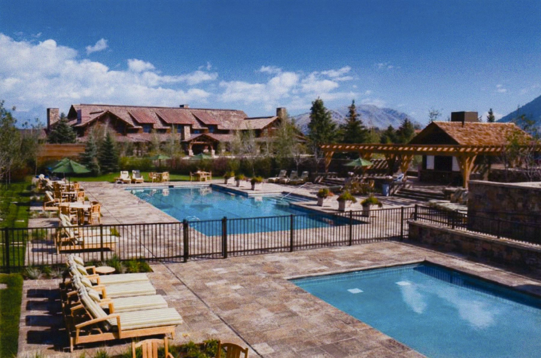 Resort amenity complex with pools and mountain backdrop