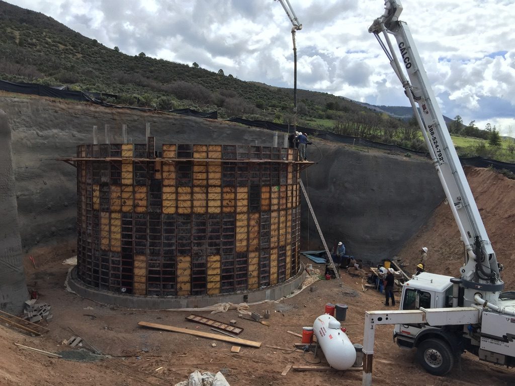 Concrete tank formwork with pump truck on site